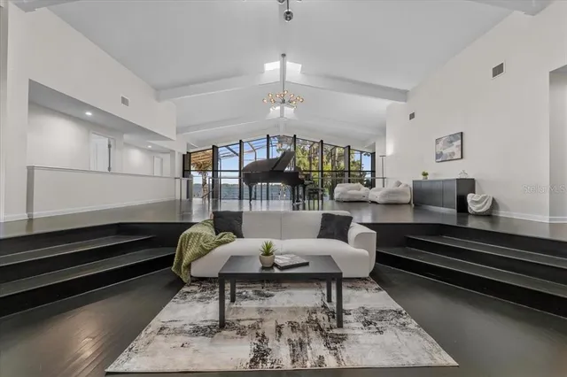 a living room with furniture and large windows