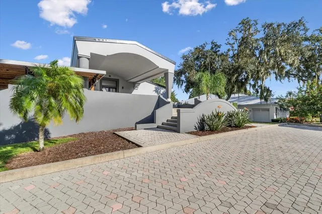 a view of a house with a garden and pathway