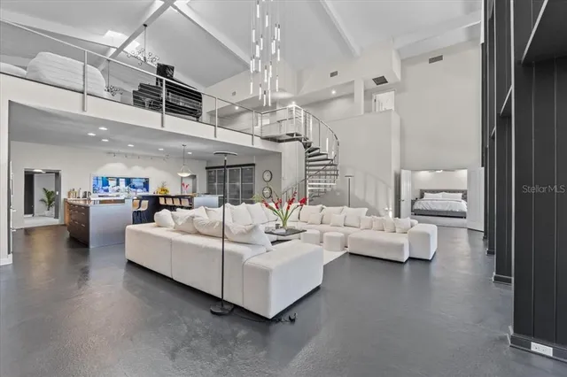 a living room with furniture white walls and a lamp
