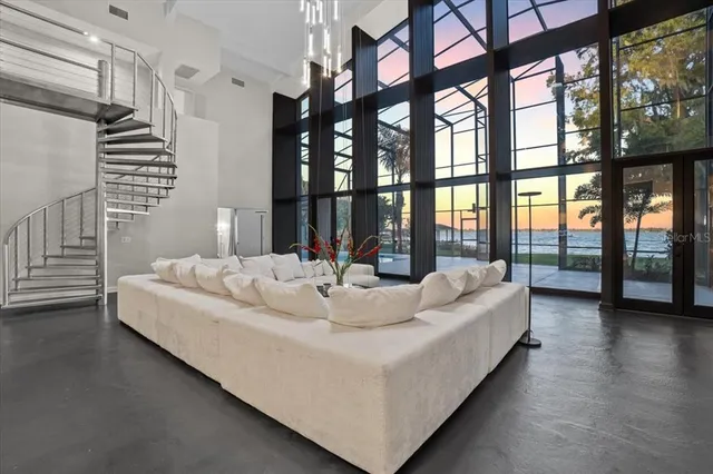 a spacious bedroom with a bed and glass door