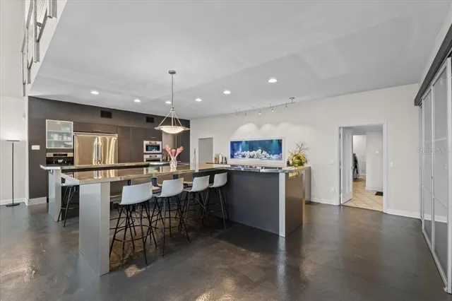 a kitchen with a sink appliances and cabinets