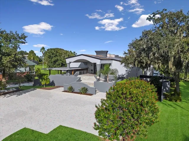 a living room with furniture a chandelier and a fireplace