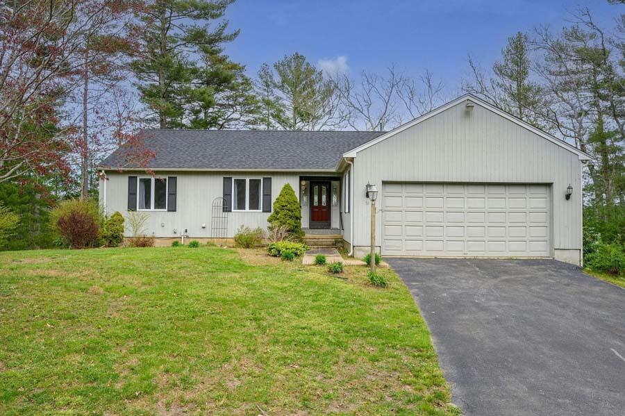 a front view of house with yard and green space