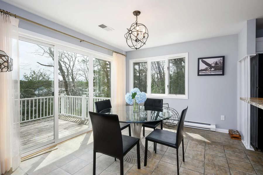 14 Arnold Road Forestdale, MA 02644 - Photo 11 of 43 a dining room with furniture a chandelier and a rug