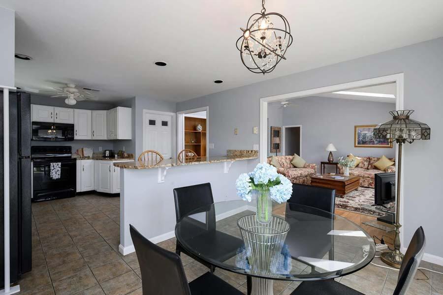 14 Arnold Road Forestdale, MA 02644 - Photo 14 of 43 a view of a dining room with furniture wooden floor and a chandelier