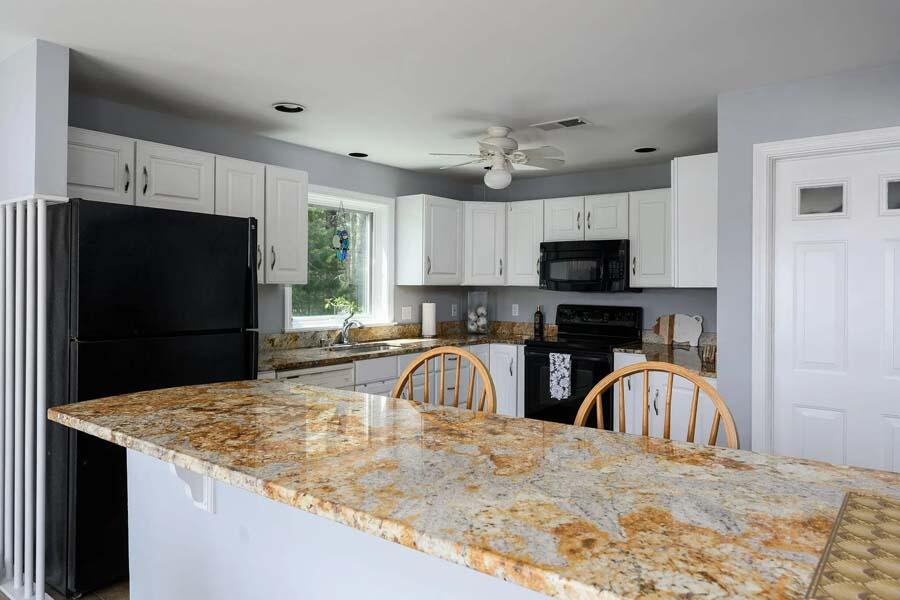 14 Arnold Road Forestdale, MA 02644 - Photo 16 of 43 a kitchen with stainless steel appliances granite countertop a sink a stove top oven a refrigerator and a granite counter tops