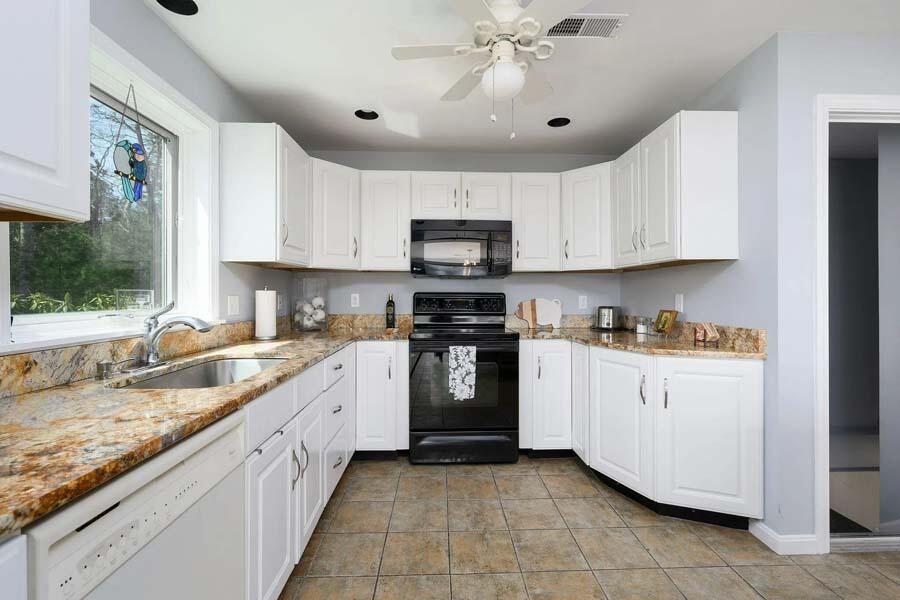 14 Arnold Road Forestdale, MA 02644 - Photo 17 of 43 a kitchen with granite countertop a sink a stove top oven and cabinets