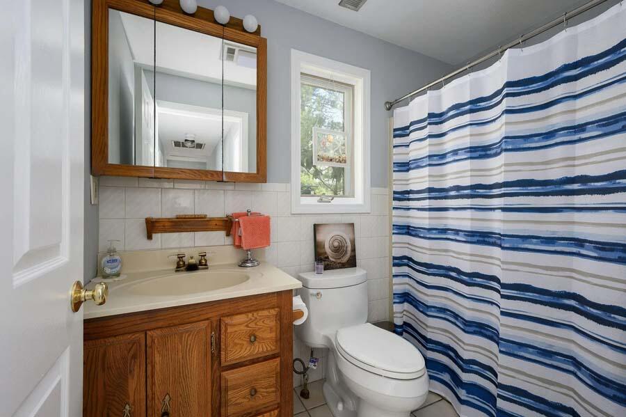 14 Arnold Road Forestdale, MA 02644 - Photo 27 of 43 a bathroom with a sink a toilet and shower curtain