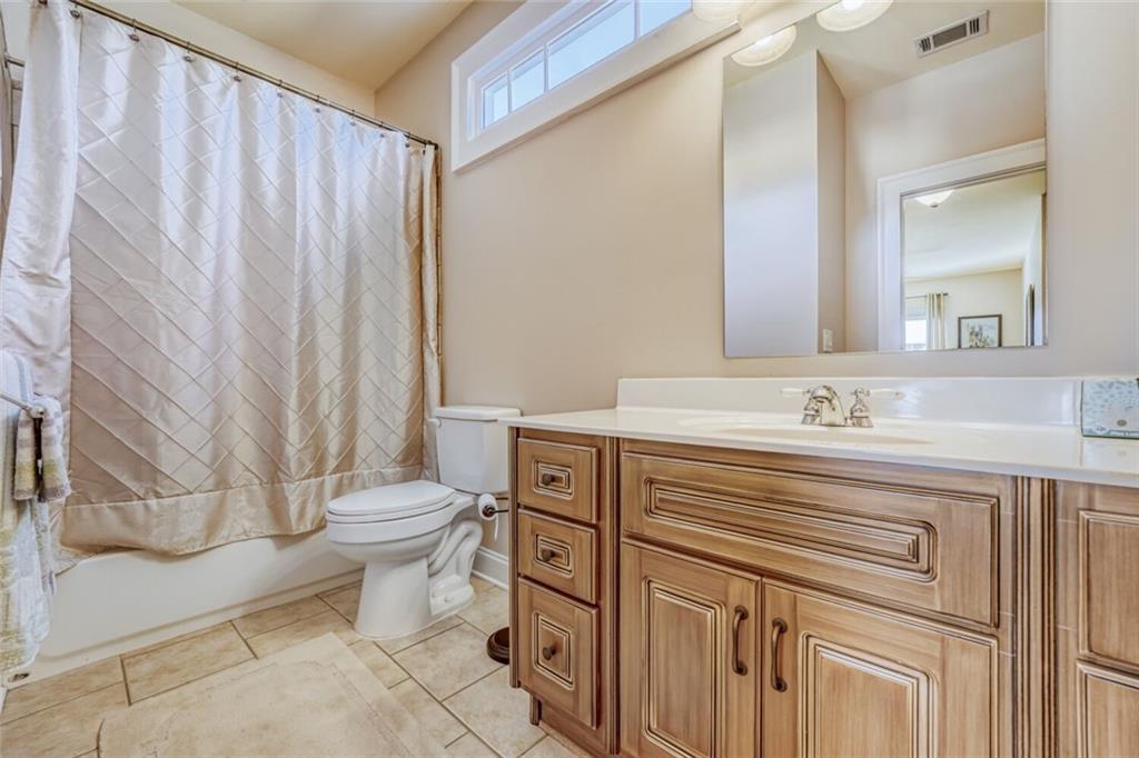 2380 Muskogee Lane Braselton, GA 30517 - Photo 29 of 30 a bathroom with a sink a toilet and shower
