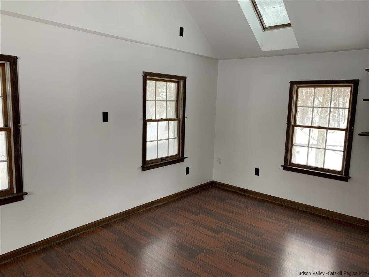205 Union Center Road Ulster Park, NY 12487 - Photo 15 of 25 an empty room with wooden floor and windows