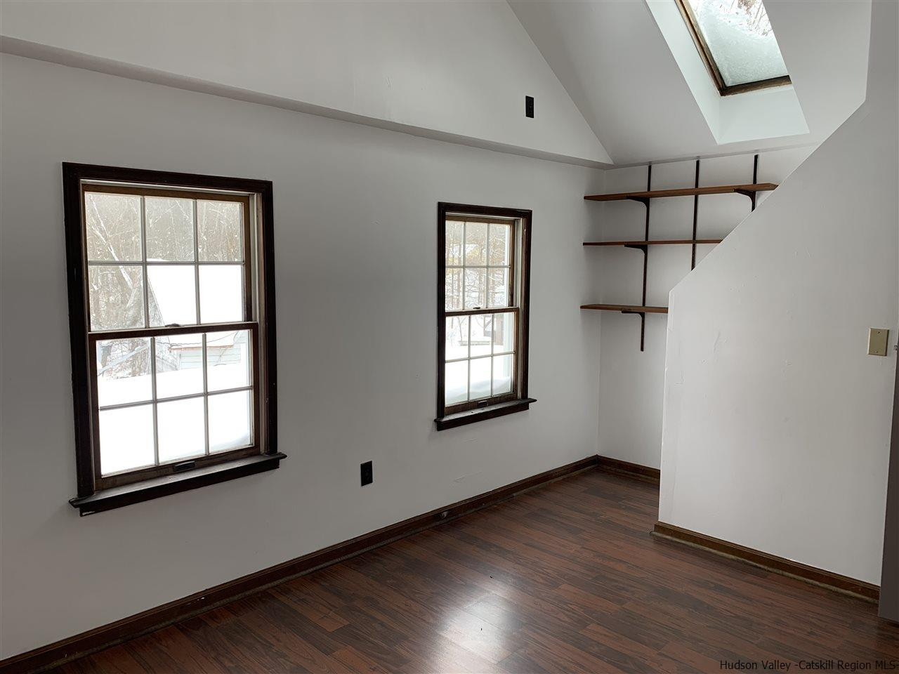 205 Union Center Road Ulster Park, NY 12487 - Photo 17 of 25 an empty room with wooden floor and windows