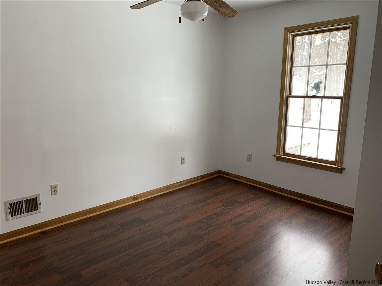 205 Union Center Road Ulster Park, NY 12487 - Photo 18 of 25 an empty room with wooden floor and windows