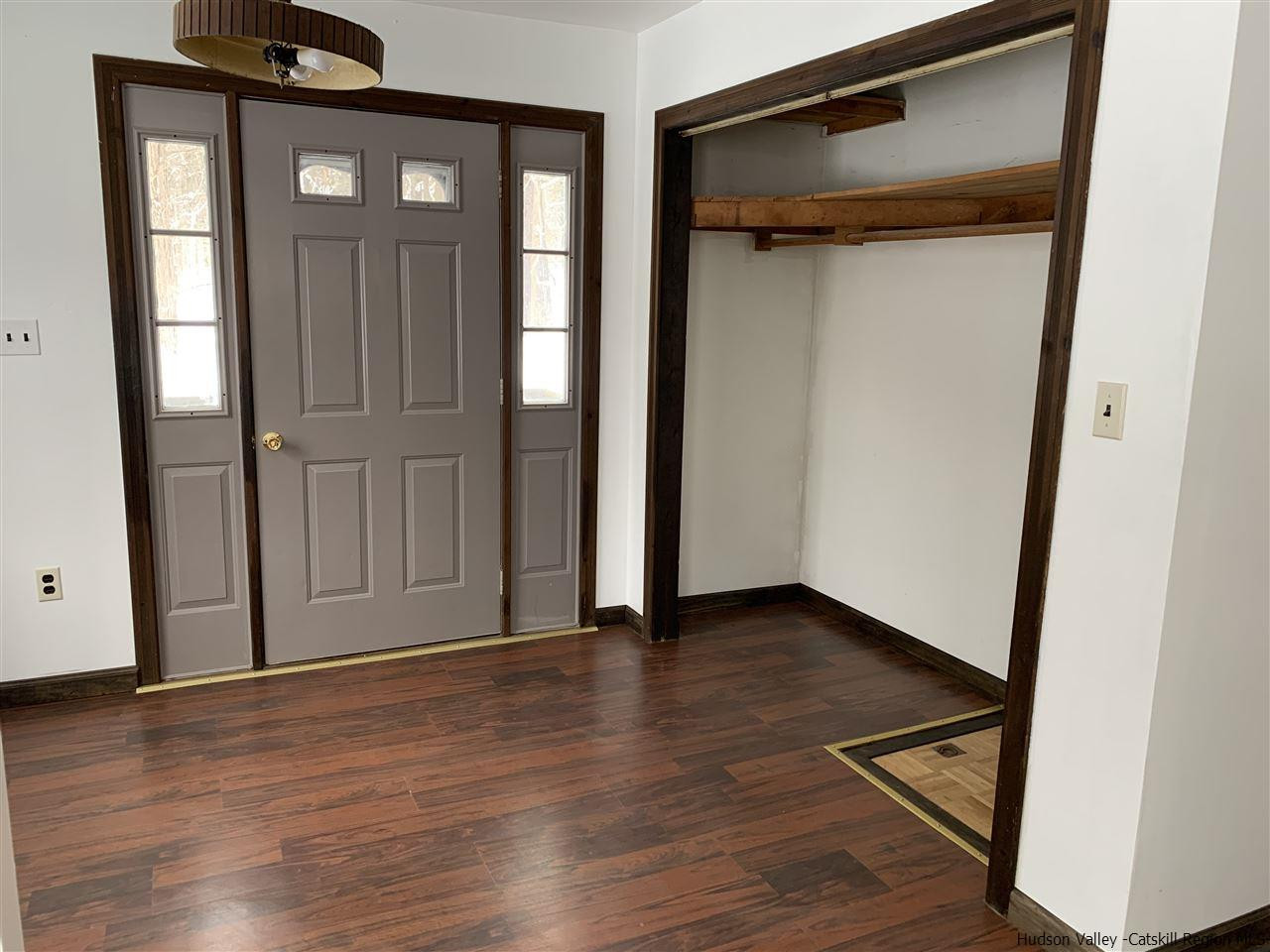 205 Union Center Road Ulster Park, NY 12487 - Photo 2 of 25 a view of an empty room with wooden floor and a window