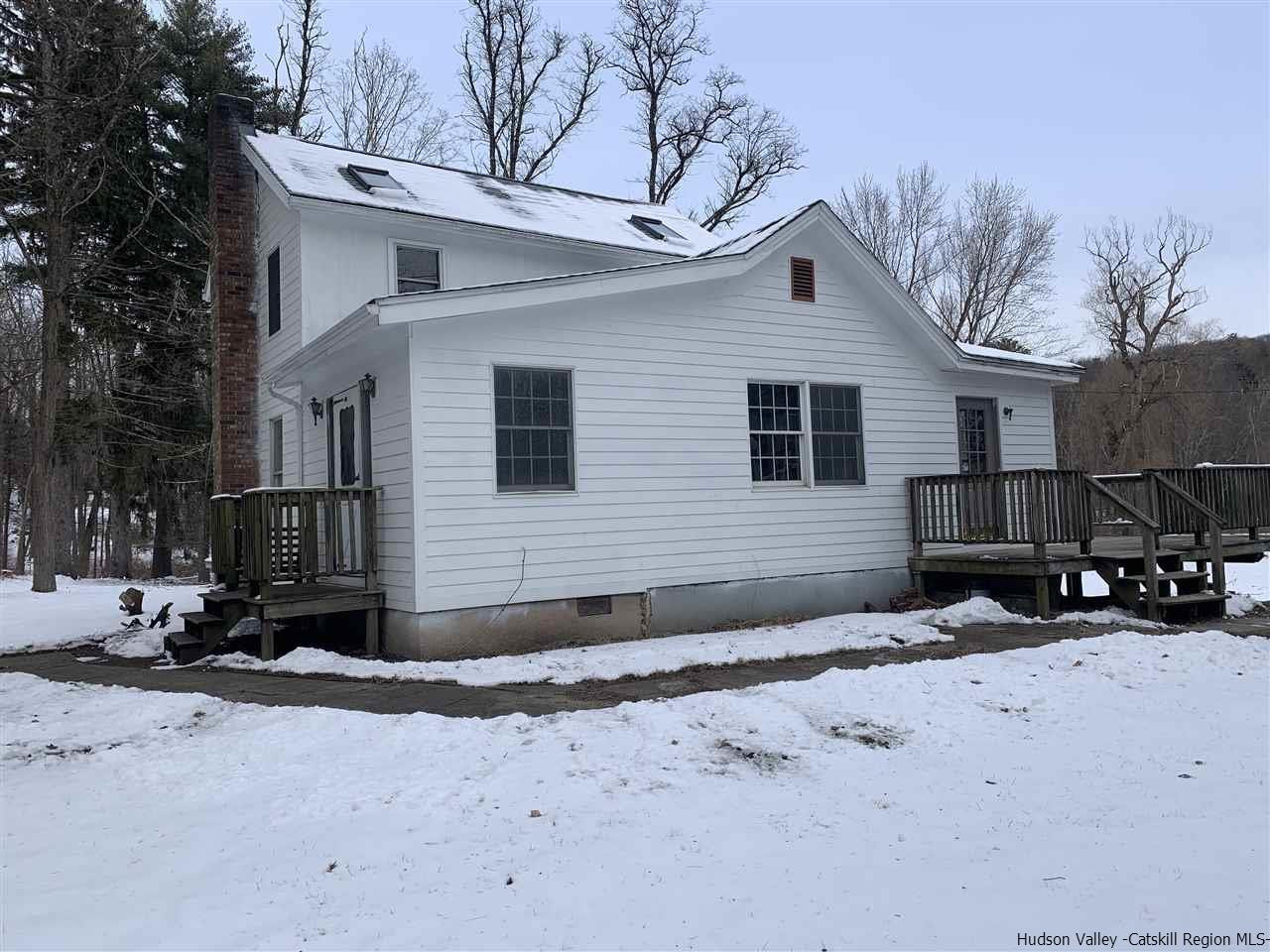 205 Union Center Road Ulster Park, NY 12487 - Photo 21 of 25 a front view of a house with a yard covered in snow