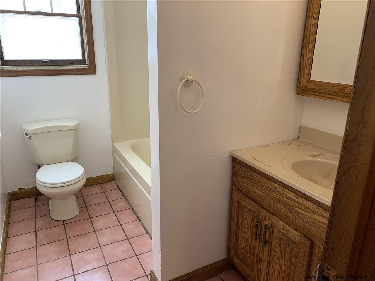 205 Union Center Road Ulster Park, NY 12487 - Photo 7 of 25 a bathroom with a sink a toilet and a mirror