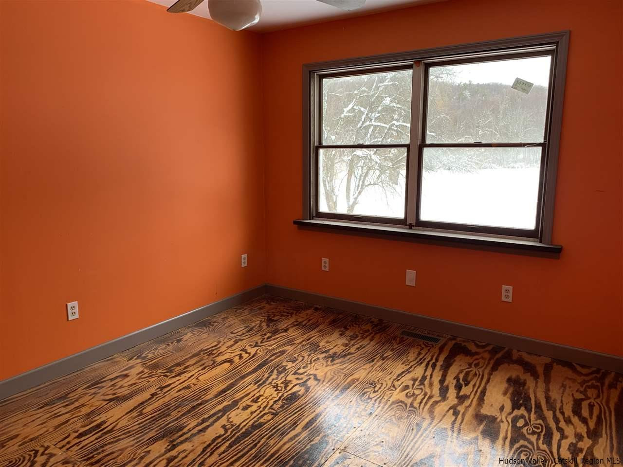205 Union Center Road Ulster Park, NY 12487 - Photo 8 of 25 a view of a room with wooden floor and windows