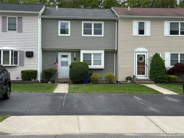 a front view of a house with a yard and a garage