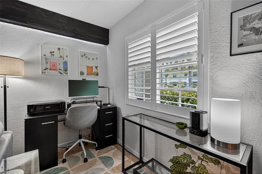 2660 Northeast 8th Avenue, Unit 208 Wilton Manors, FL 33334 - Photo 11 of 49 a view of a workspace with furniture and a window