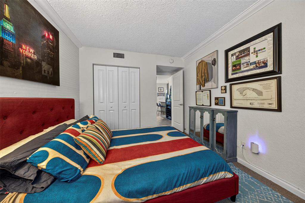 2660 Northeast 8th Avenue, Unit 208 Wilton Manors, FL 33334 - Photo 18 of 49 a bedroom with a bed and a painting on the wall