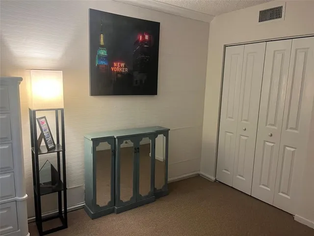 a view of a livingroom with workspace and a window