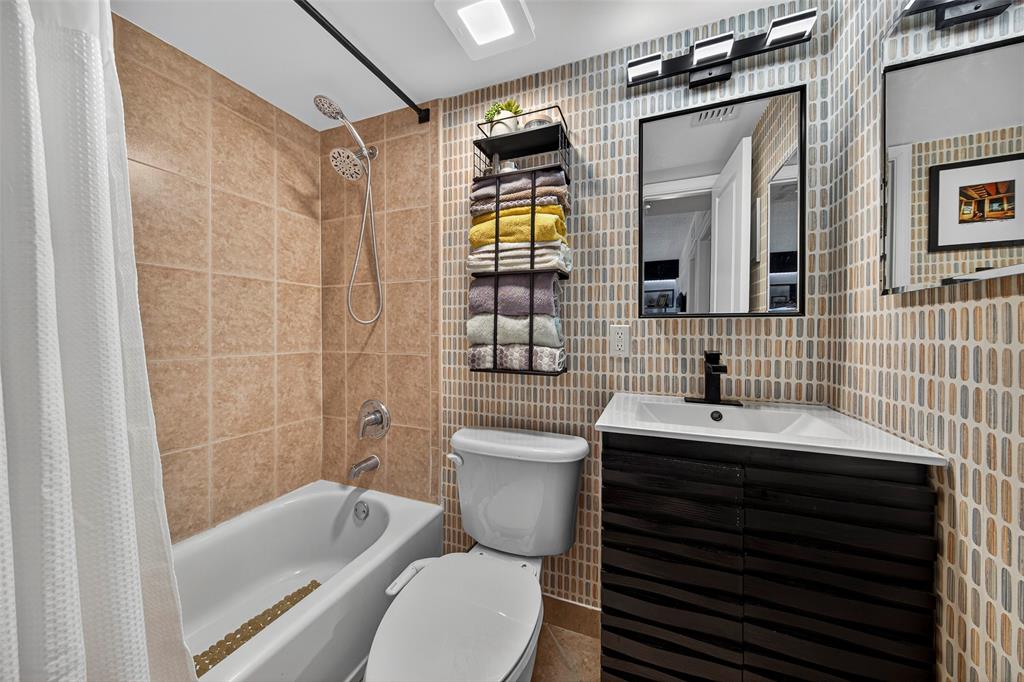 2660 Northeast 8th Avenue, Unit 208 Wilton Manors, FL 33334 - Photo 22 of 49 a bathroom with a sink a toilet and shower