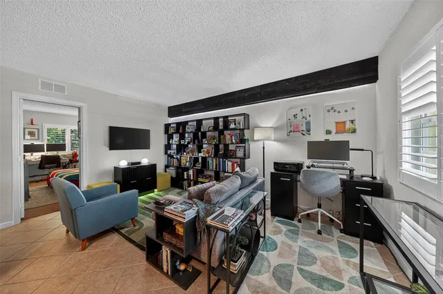 a view of a livingroom with workspace and a couch