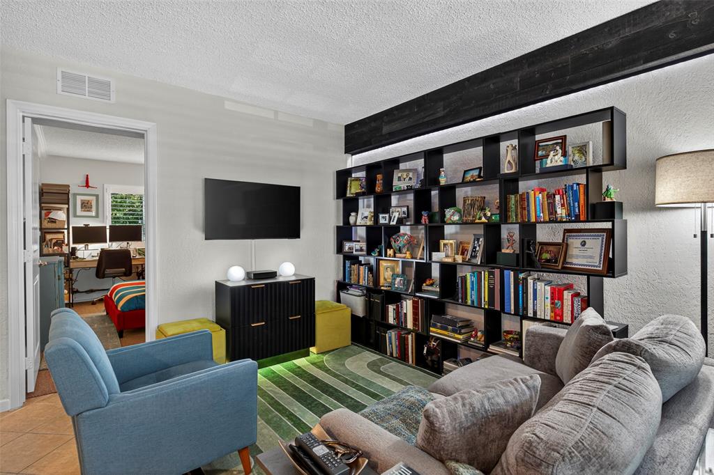 2660 Northeast 8th Avenue, Unit 208 Wilton Manors, FL 33334 - Photo 9 of 49 a living room with furniture workspace and a flat screen tv