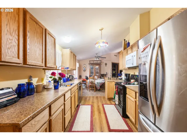 a kitchen filled with a refrigerator and a sink