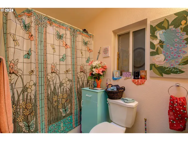 a bathroom with a toilet sink and shower curtain