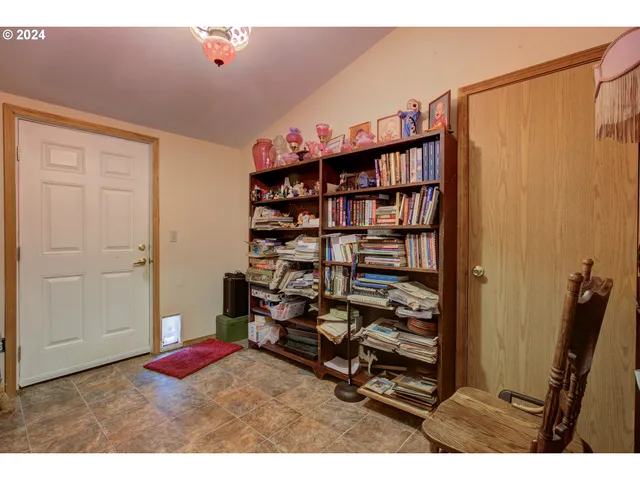 a bedroom with a book shelf