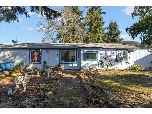 a view of a house with backyard sitting area and garden