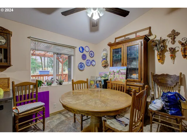 a view of a dining room with furniture and window