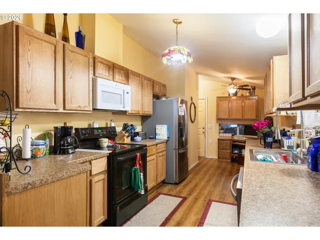 a kitchen that has a lot of cabinets and refrigerator