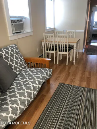 a bedroom with two beds lamp and a large window