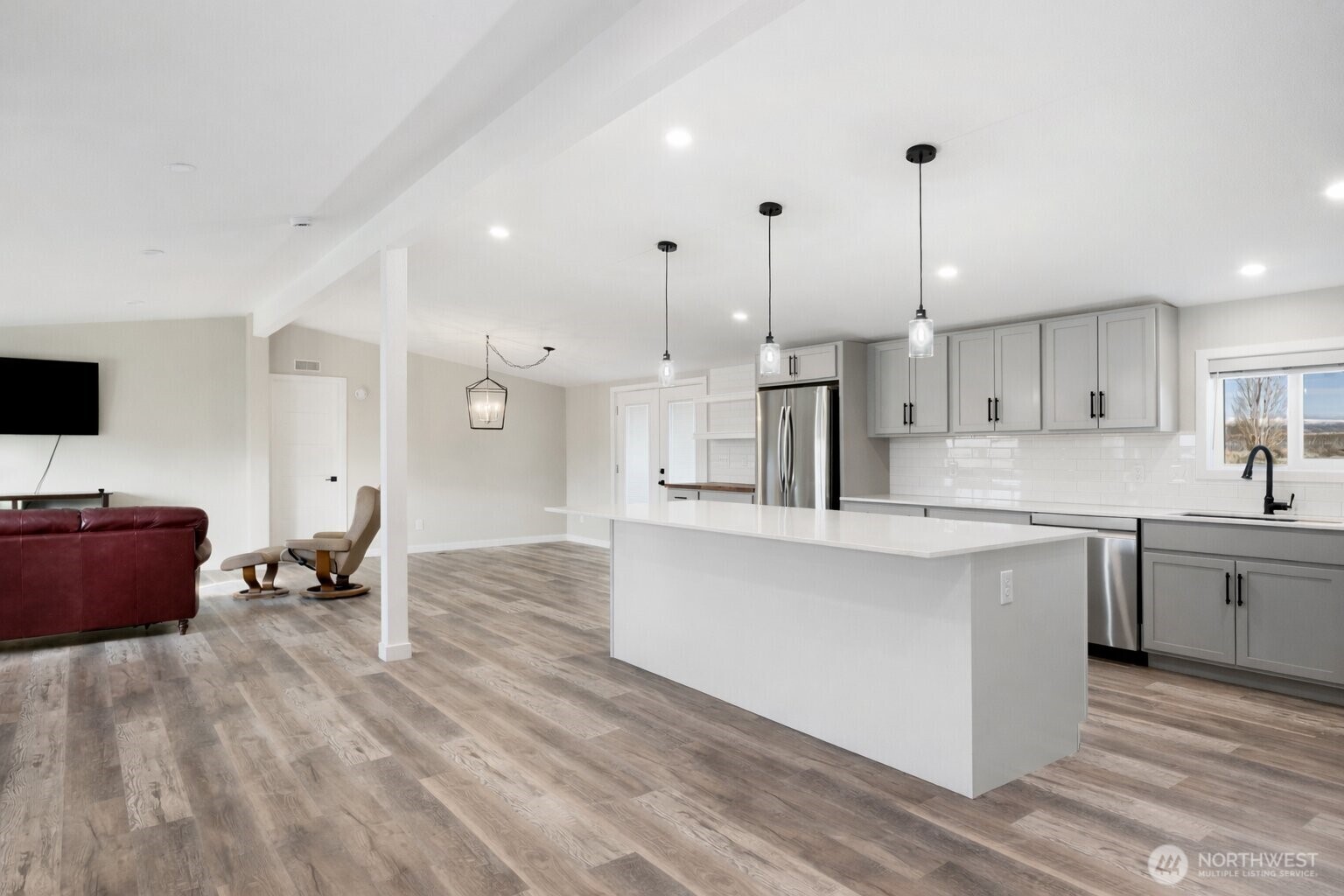 734 Lakeside Way Mattawa, WA 99349 - Photo 4 of 34 a large kitchen with cabinets a sink a window and stainless steel appliances