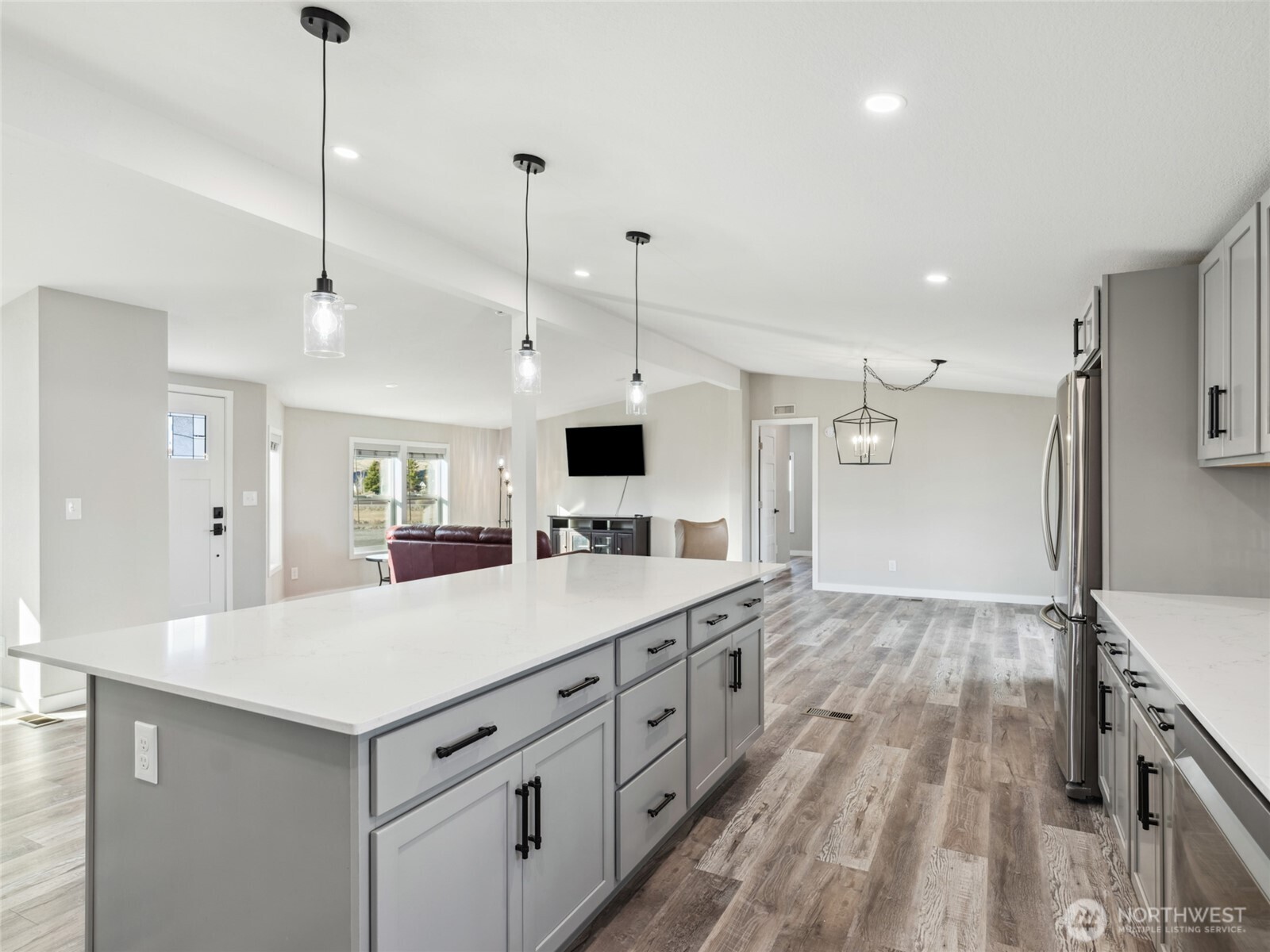 734 Lakeside Way Mattawa, WA 99349 - Photo 7 of 34 a large kitchen with kitchen island a sink stove and wooden floor