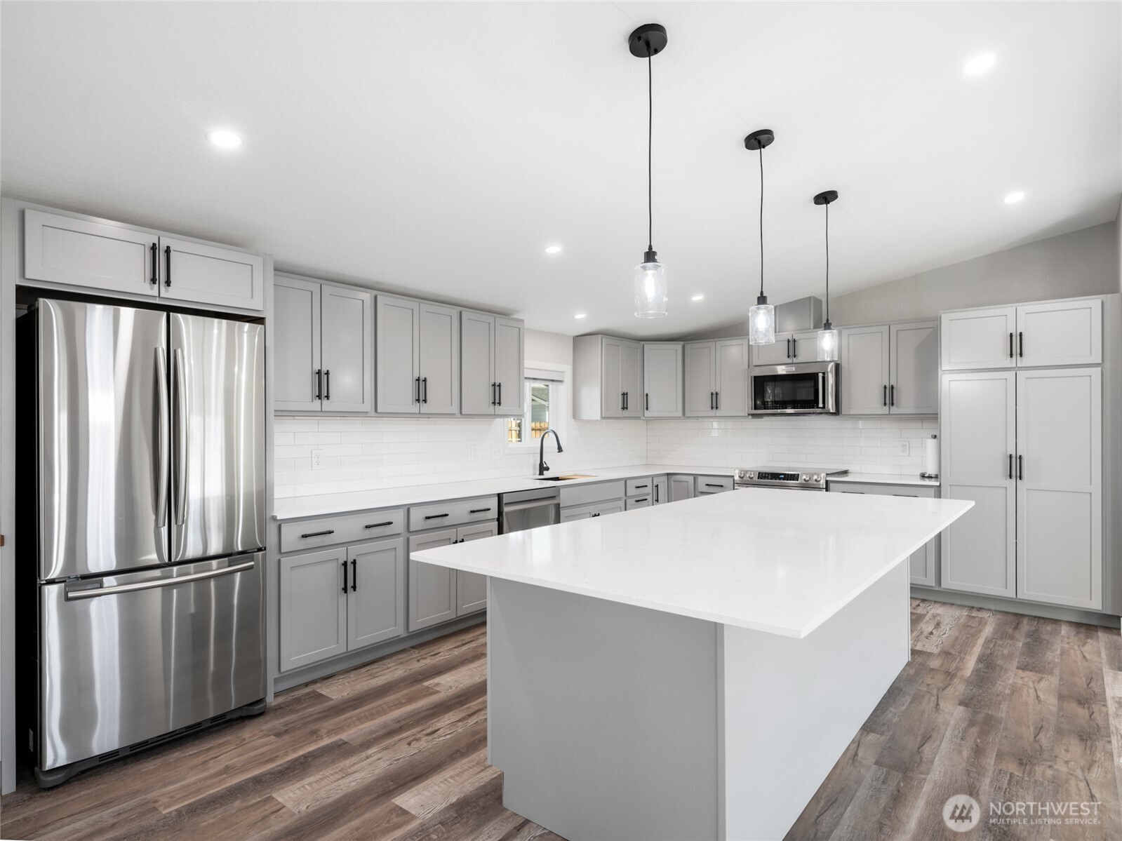 734 Lakeside Way Mattawa, WA 99349 - Photo 8 of 34 a kitchen with stainless steel appliances a stove a sink a refrigerator a center island and chairs
