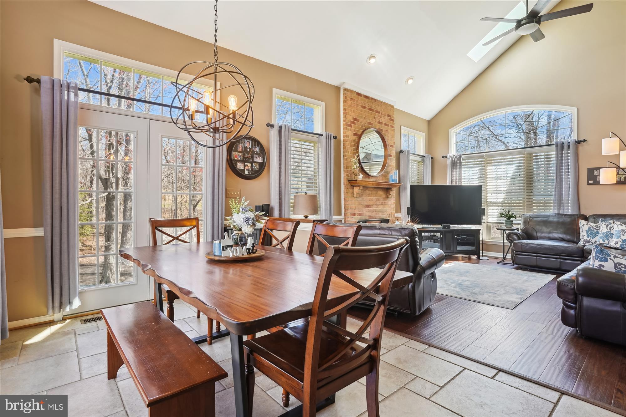 8535 Oak Chase Circle Fairfax Station, VA 22039 - Photo 13 of 62 a view of a dining room with furniture a chandelier and wooden floor