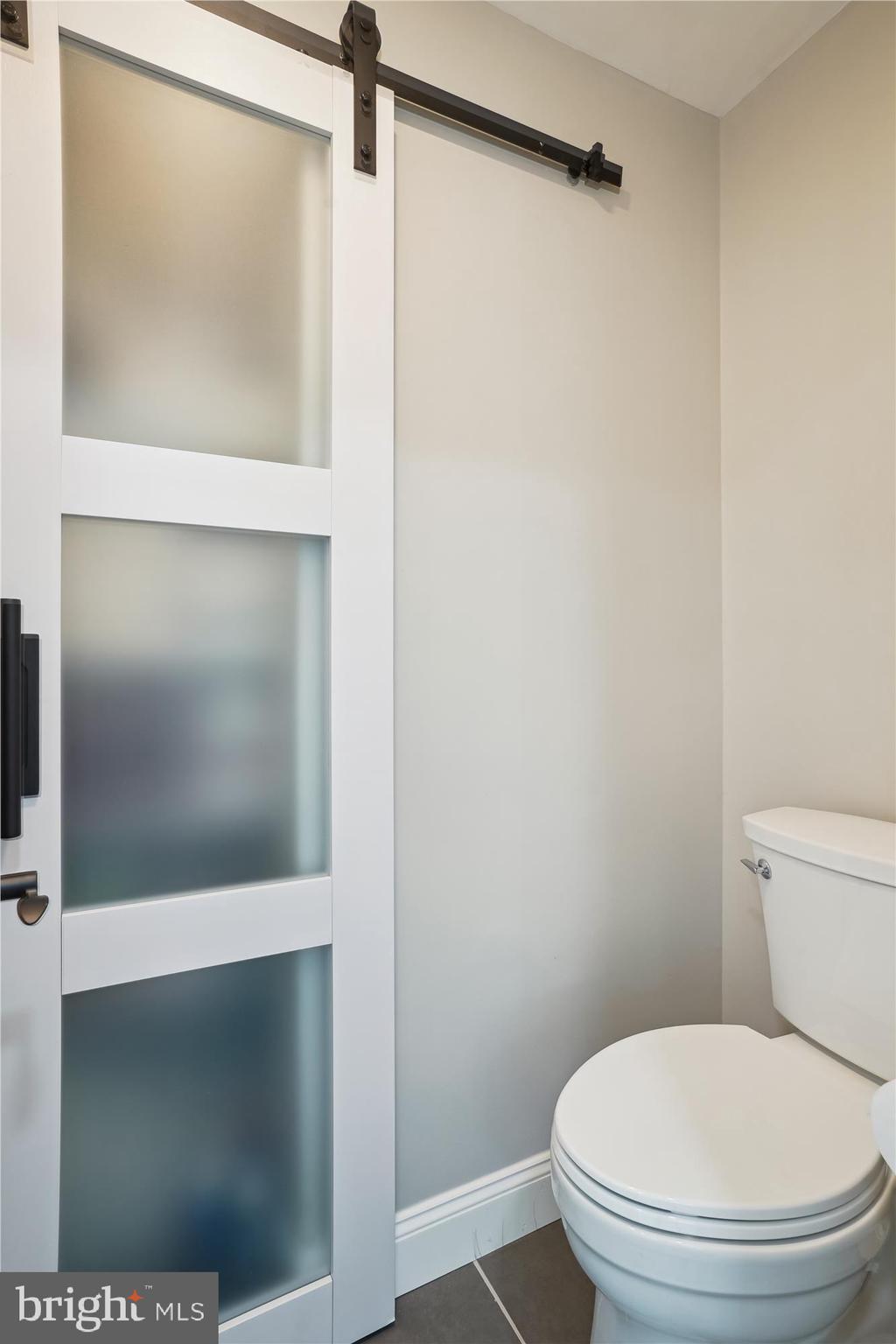 8535 Oak Chase Circle Fairfax Station, VA 22039 - Photo 37 of 62 a white toilet sitting next to a shower