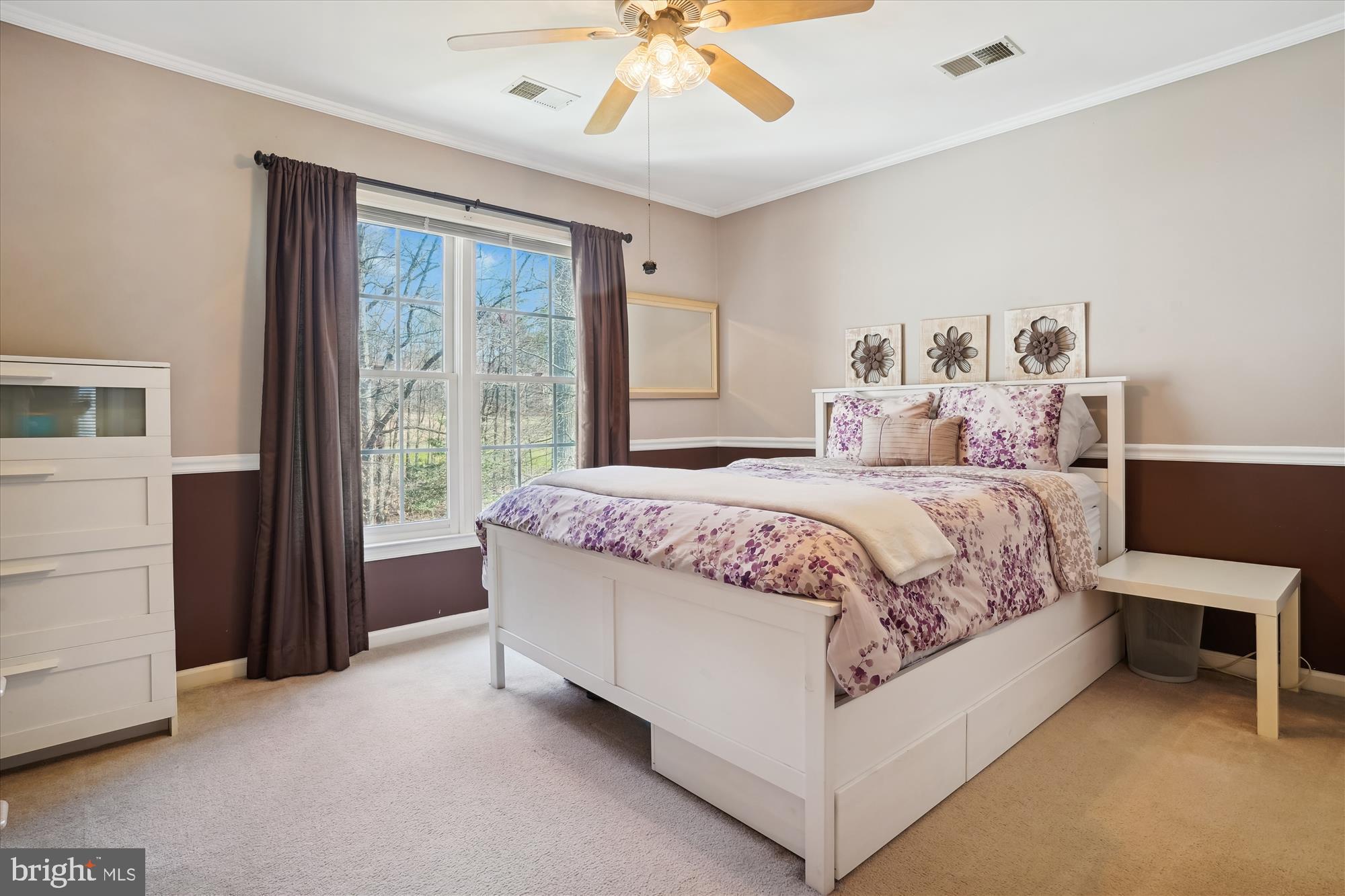 8535 Oak Chase Circle Fairfax Station, VA 22039 - Photo 39 of 62 a bedroom with a large bed and a chandelier