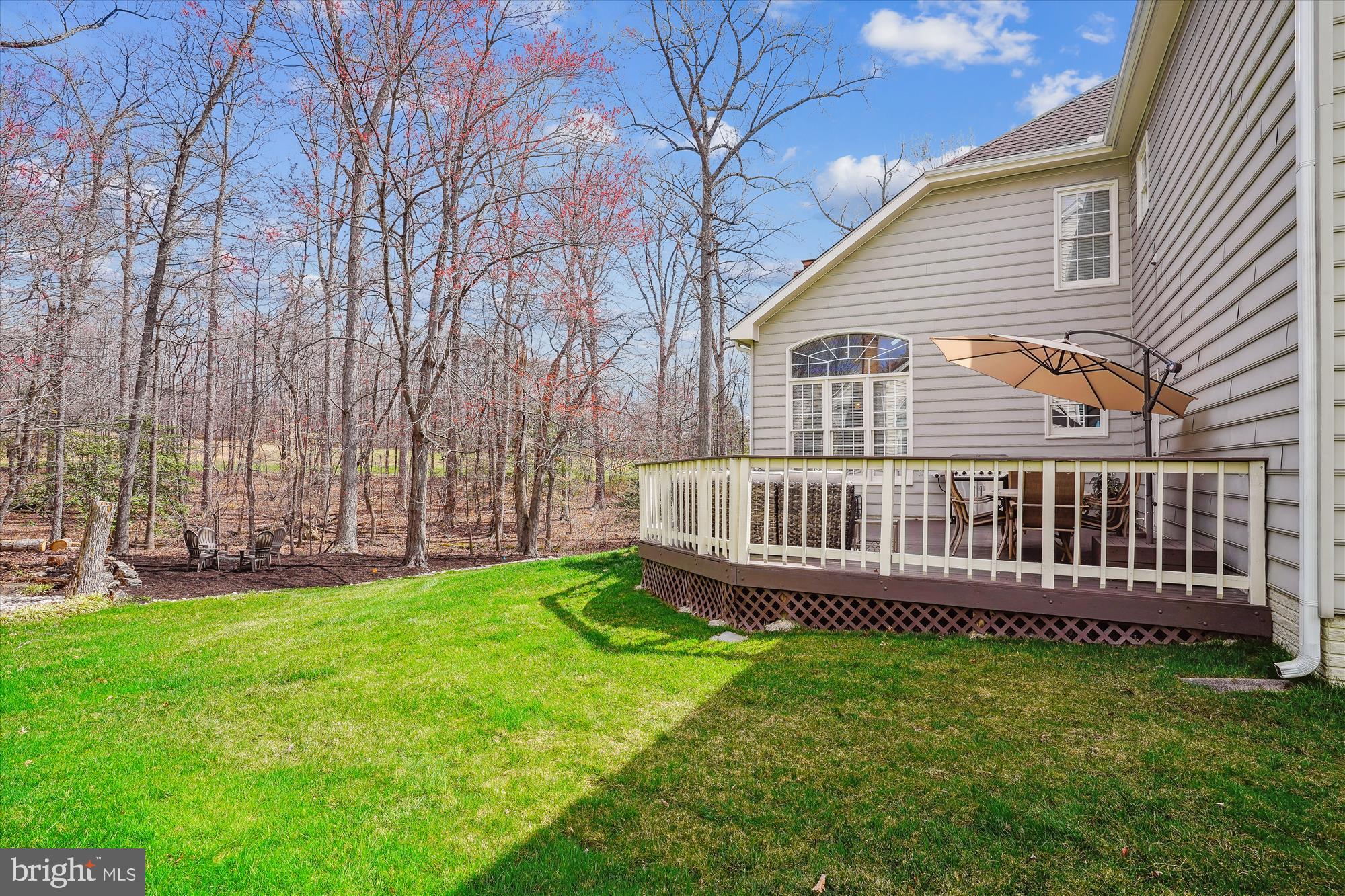 8535 Oak Chase Circle Fairfax Station, VA 22039 - Photo 52 of 62 a view of a house with a backyard and deck