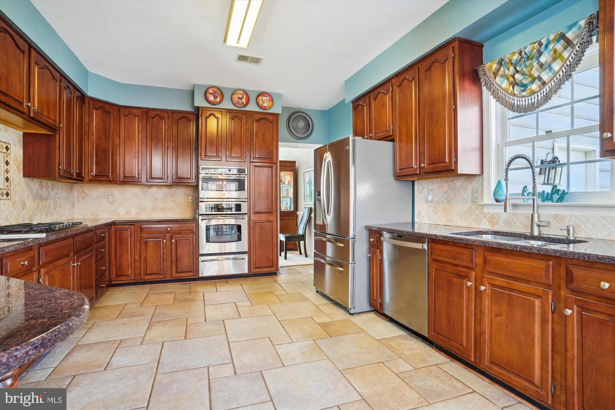 8535 Oak Chase Circle Fairfax Station, VA 22039 - Photo 9 of 62 a kitchen with stainless steel appliances granite countertop a refrigerator and a stove top oven