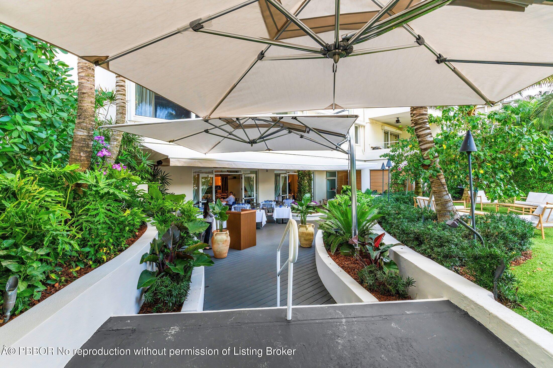 44 Cocoanut Row, Unit 526B Palm Beach, FL 33480 - Photo 30 of 33 a view of a patio with table and chairs potted plants