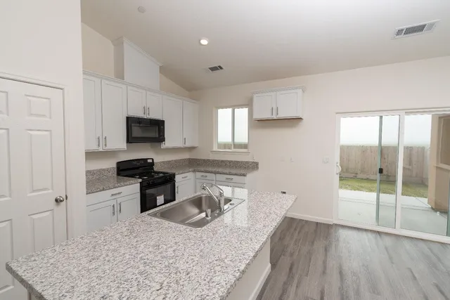 an aerial view of residential houses with an outdoor space