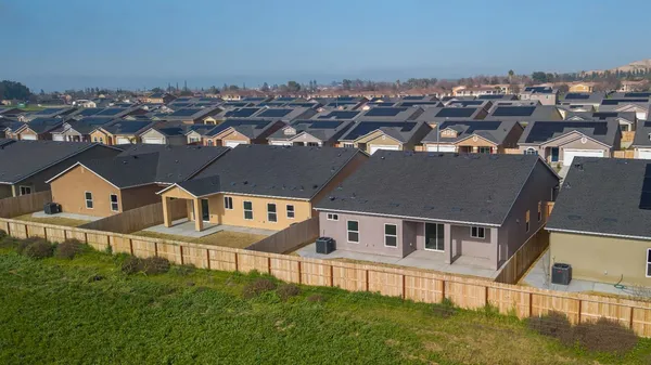 a view of a house with large windows