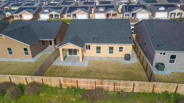 an aerial view of multiple houses with a yard