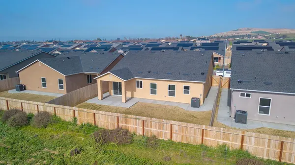 an aerial view of a house with a ocean view