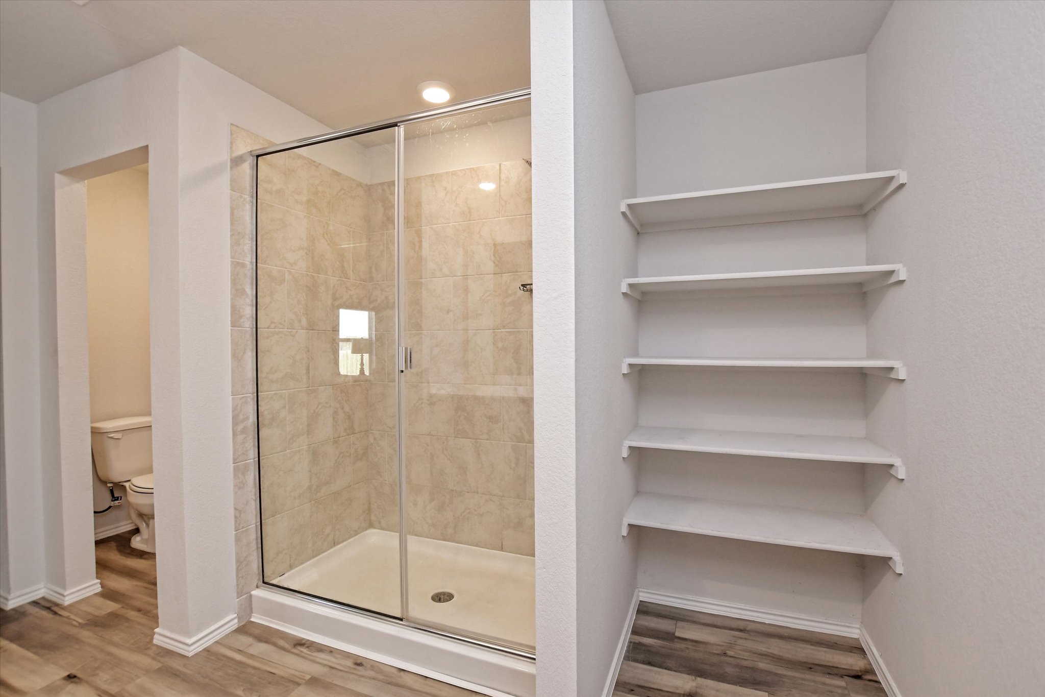 508 Wyatt Way Jarrell, TX 76537 - Photo 14 of 27 Primary bathroom has separate water closet, shelving and spacious shower