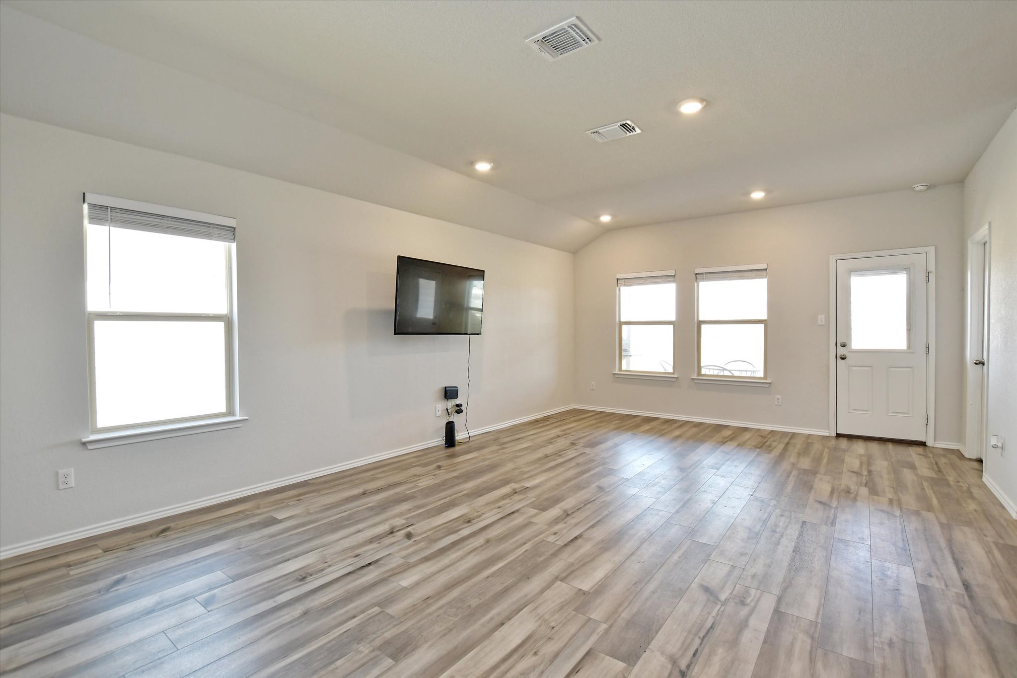 508 Wyatt Way Jarrell, TX 76537 - Photo 4 of 27 living room with light luxury vinyl plank floors, lofted ceiling, and recessed lighting