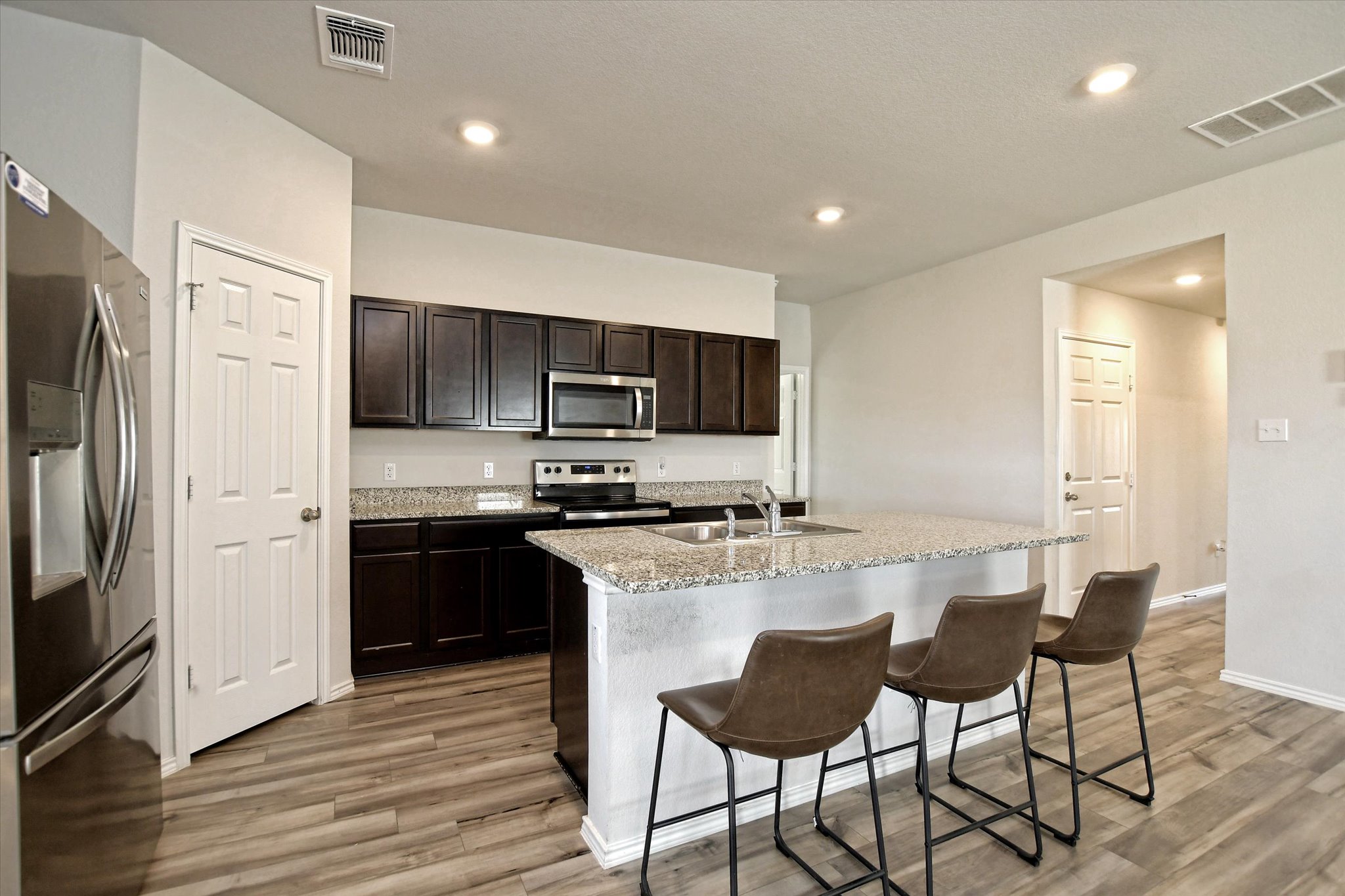 508 Wyatt Way Jarrell, TX 76537 - Photo 6 of 27 The light-dark contrast in this modern answer to kitchen styel